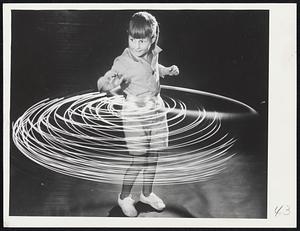 Time-lapse photograph of child with hula hoop