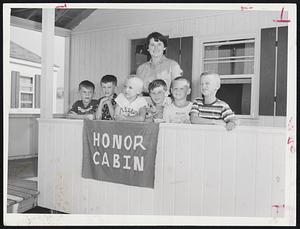 Proud of Their Honors are these six infantile paralysis victims and their counselor, Marilyn Hanley, 19, of Haverhill. The boys earned the award of "Honor Cabin" at Sea Haven Camp on Plum Island. They are (left to right) Danny Howard of Beverly, Sandor Rosenberg of Lynn, Steve Madolna of Lynn, Donny Boyce of Lynn, Alan Weed of Marblehead and Carl Person of Marblehead.