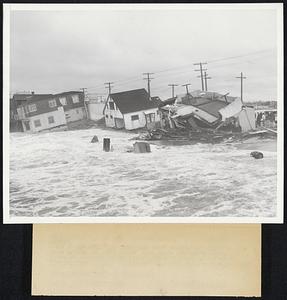Beach Homes Damaged by Heavy Surf (near Long Beach, Calif;) ---Photo Shows- Three beach homes on the seaward side of Alamitos Bay which were damaged by giant waves, when their foundations were out away by the surf. The homes are being pounded to pieces by the waves.