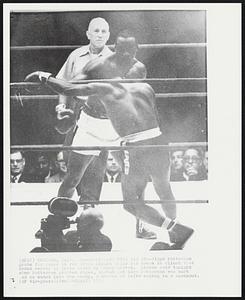 Sonny Says This Did It--Floyd Patterson grabs for ropes as red Frank Sikora calls for break in clinch that ended series of lefts aimed by Sonny Liston. Liston said tonight when Patterson grabbed ropes, Liston got idea Patterson was hurt and he waded into the champ, a series of lefts ending in a knockout.
