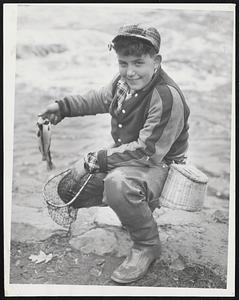 Proud Angler Harold Legge of South Natick displays two brookies he caught in the Charles river at the opening of the Massachusetts trout season yesterday.