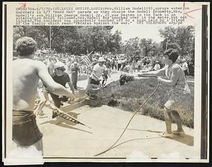 Mrs. William Hodell(R), sprays water on marchers 6/7 "Hard Hat" parade as they charge the Hodell property. Mrs. Hodell's son, William George Hodell Jr., 22, was beaten in the face in an altercation which followed. Mrs. Hodell was knocked over in the melee, but not injured. The incident was apparently touched off by a sign held by a friend of the family which read: "Veteran against the war."