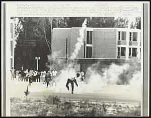 Opa Locka, Fla: Students returns tear gas canister during demonstration at predominantly black Florida Memorial College here 5/18. Riot police firing canisters of tear gas touted about 200 demonstrators and forcibly removed a small group of students which took over the administration building. Student.