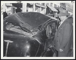 The Inspector Inspects, and since that's his own car he's looking at he feels unhappy. One of New Bedford's flying chimneys crashed on top of it during the hurricane. Owner is Police Inspector John Mendonca.