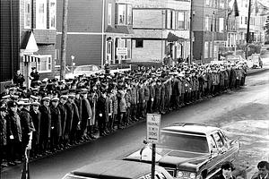 Firefighters from several communities lineup in front of the Assumption Church