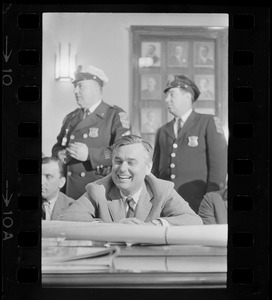 Edward J. Logue of the Boston Redevelopment Authority during hearing, with police officers right behind him