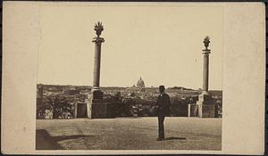 Unidentified man in front of two columns