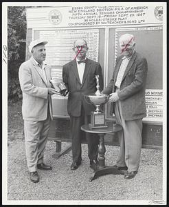 Charley Sheppard, left, of Brae Burn Country Club accepts trophy and plaque for winning the 1957 New England Section PGA Seniors golf championship at Essex County Club. Making presentation is Edward Adnapoz of Schieffelin Company, national sales representative for William Teachers & Sons, Scotland. NEPGA President Tom Mahan of United Shoe is on the right.