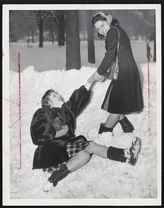 'Oops, My Dear'-Barbara Elliott of Allston, who lost her footing as a result of the slippery going created by yesterday's combination of snow, sleet and rain is aided to her feet by Eleanor Marrone of Allston.