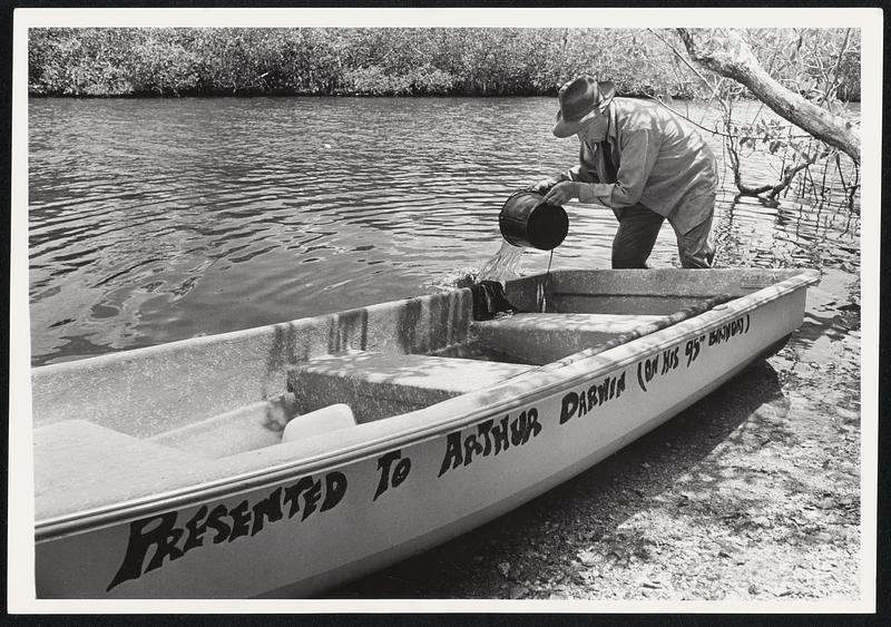 Arthur Darwin bails out the boat which is his only means of contact with the outside world. His world is Posseam Key, a small Island in Everglades National Park, Fla., reachable only by boat. Darwin leaves the island, where he lives alone, only once a month to visit Everglades City in the skiff with its five horse power engine: it takes about two hours each way. He's lived on the island for 26 years now, and decided to settle not "looking to get away from the world." He just liked it there.