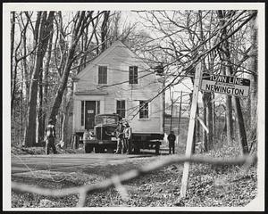 House Moving in New Hampshire- Despite the controversy over the huge air field planned at Newington near Portsmouth, N.H., moving of homes on the site continues daily. Here a truck bears a home past Newington town line for a five-mile trip to a new site at Greenland, N.H.