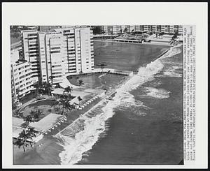 Tides, Waves Flood Hotels--Waves and high tides today battered at Miami Beach plush hotel row flooding swimming pools and cabana play areas. Flooded streets in some parts of Miami Beach forced traffic to detour