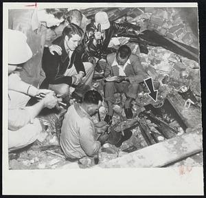 Talking With Trapped Tornado Victims- Rescue workers keep up the spirits of two 17-year-old boys, trapped beneath the pile of rubble that formerly was a recreation club in the downtown section of Waco before a tornado demolished the structure.