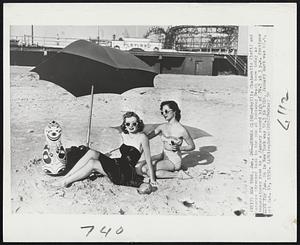 New York – Sumer Clime – Phyllis Chaimowitz (left) and Dolores Strocker bask in the sun at Rockaway Beach here today as temperature rose to a January record high of 70.5 at 3 p.m. Previous mark for Jan. 26 in New York was 58.3 in 1916. January mark was 68.4, set Jan. 14, 1932.