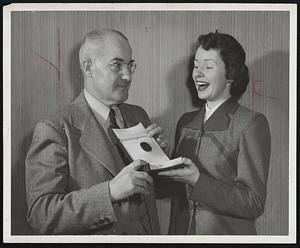 World’s Largest Faceted Sapphire, which will be on display at Smith Patterson for week beginning tomorrow, draws an excited gasp from Martha Lee, Wellesley, as she peers at the huge gem in the hands of Frank M. Libbey, general manager of the store.