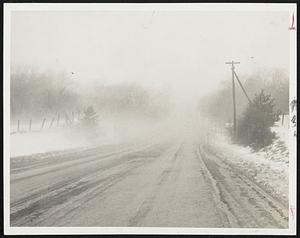 New England Has Everything in the way of weather and usually too much of it in one dose. This photograph shows how Route 3A in Hingham was shrouded in fog so that traffic and auto lights were barely visible. The picture was take near the junction of Route 128.