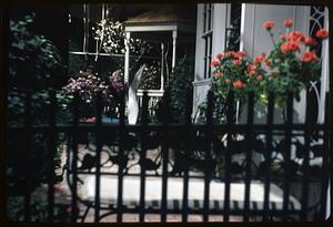 Flowers by a gazebo behind a gate