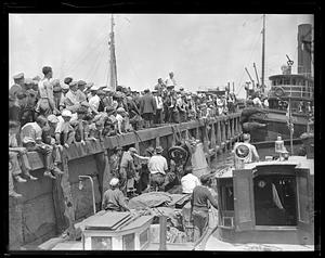 A crowd of people looking out from a pier