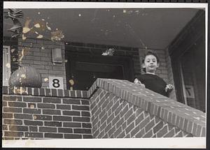 Child looking down from a staircase