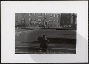 Young child sitting in Newtowne Court