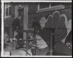 Pam Williams and other children playing on stair railings
