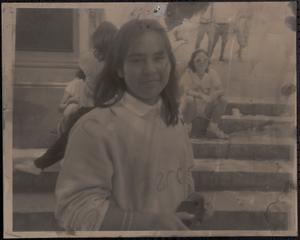 Young woman smiling in front of bridge steps