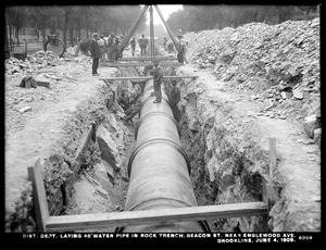 Distribution Department, Low Service Pipe Lines, 48-inch pipe, laying pipe in rock trench, Beacon Street near Englewood Avenue, Brookline, Mass., Jun. 4, 1909
