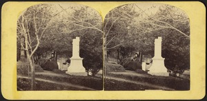 Woman seated near a headstone