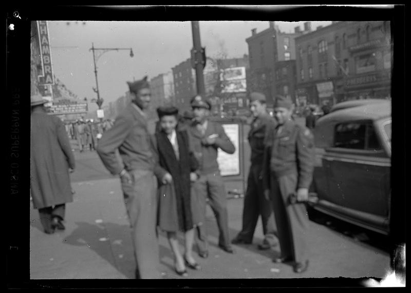 Group in military uniforms on street with Alhambra sign