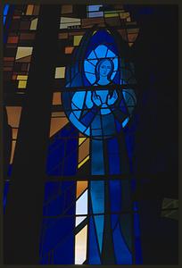 Stained glass window depicting woman, possibly Virgin Mary