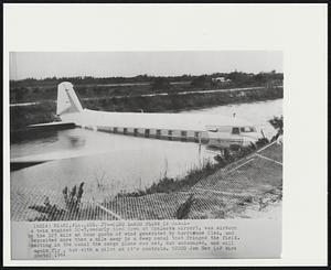Cleo Lands Plane in Canal-A twin engined DC-3, securely tied down at Opalacka airport, was airborn by the 125 mile an hour gusts of wind generated by hurricane Cleo, and deposited more then a mile away in a deep canal that fringed the field. Resting in the canal the cargo plane was wet, but undamaged, and will again fly, but with a pilot at it's controls.