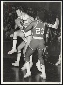 Holding On - Kevin Shea (22) of Northeastern wins battle for rebound with Tom Taylor (23) of Boston University in game at Cabot Cage.