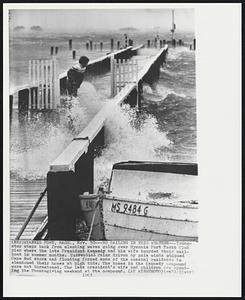 Hyannis Port, Mass. - No Sailing In This Weather - Youngsters steps back from slashing waves going over Hyannis Port Yacht Club pier where the late President Kennedy and his wife boarded their sailboat in summer months. Torrential rains driven by gale winds whipped Cape Cod shore and flooding forced some of the coastal residents to abandoned their homes at high tide. The homes in the Kennedy compound were not threatened. The late president's wife and children are spending the Thanksgiving weekend at the compound.