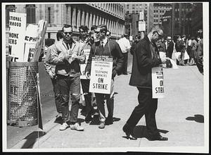 Mass Picket Lines of striking Telephone Company workers circling company headquarters of Franklin St., yesterday in show of confidence.