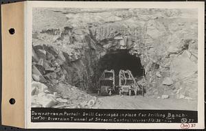 Contract No. 30, Stream Control Works at Main Dam, Swift River Reservoir, Belchertown, Enfield, Ware, downstream portal, drill carriages in place for drilling bench, diversion tunnel of stream control works, Belchertown, Mass., May 2, 1932