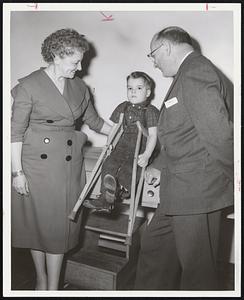 Crippled by Polio in the 1955 epidemic, David J. Leary of Mattapan, almost 4, is one of 9,000 New England victims in need of March of Dimes aid for rehabilitation. With David are Mrs. Frank J. Lyons of Jamaica Plain and Leo F. Dunphy of Milton. They are leaders of the Suffolk County campaign for the March of Dimes.