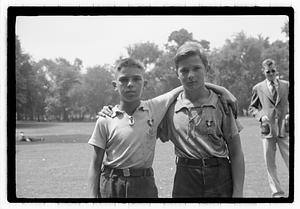 Two boys, both wearing medals