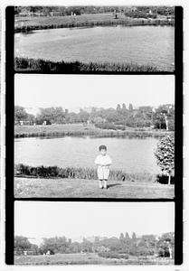 Unidentified boy in front of a body of water by the Museum of Fine Arts, Boston