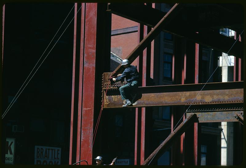 Construction worker on steel frame of building, Boston