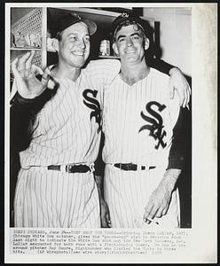 They Beat the Yanks--Grinning Sherm Lollar, left, Chicago White Sox catcher, gives the "goose-egg" sign in dressing room last night to indicate the White Sox shut out the New York Yankees, 2-0. Lollar accounted for both runs with a first-inning homer. He has an arm around pitcher Ray Moore, righthander who limited the Yanks to three hits.