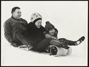 Tobogganing at Larz Anderson Park, Brookline, yesterday were Joe Benoit of Clinton, Susan Landers of Brookline and her daughter, Susan, 5.