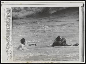 Rescue in Stormy Sea - A volunteer firemen from Rehoboth Beach, Del., swims through boiling water in lower Delaware Bay today to side of an oil barge crewman washed overboard after the barge, struck by heavy seas and high winds, broke loose from his tug.