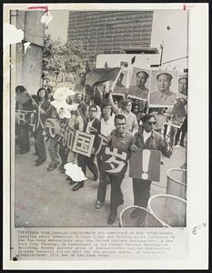 Demonstrate for Admission of Red China-Youths carrying small Communist Chinese flags and holding aloft portraits of Mao Tse-tung demonstrate near the United Nations headquarters in New York City Tuesday. In background is the United Nations Secretariat Building. Nearby another group of demonstrators carried Nationalist Chinese banners. Police kept the two groups apart.