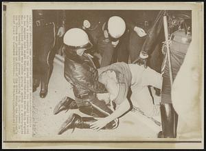 Police Subdue a Recalcitrant--Police wrestle a demonstrator to the ground outside the Century Plaza hotel in Los Angeles last night during a rock-throwing melee which erupted while President Johnson was inside giving a speech at a $500-a-plate dinner. Several thousand persons protesting U.S. involvement in the Vietnam war paraded in front of the hotel during the President's brief visit to southern California.