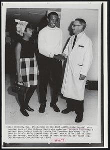 Sayers on His Feet Again--Gale Sayers, star running back of the Chicago Bears who underwent surgery following a serious knee injury Sunday, thanks Dr. Theodore Fox today. With them is Gale's wife, Linda. Star player, who will be lost to team for the reason, was able to walk on cast enclosing his right leg.