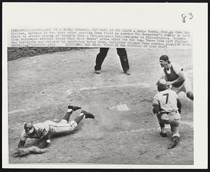 Banks Sprawls, But Safe at the Plate - Ernie Banks, Chicago Cubs infielder, sprawls in the dust after scoring from first on catcher Vic Roznovsky's double to left field in second inning of today's Cubs - Philadelphia game in Philadelphia. Catcher Clay Dalrymple watches loose ball near Banks' elbow after try for tag. Throw from left fielder Wes Covington was relayed by shortstop Bobby Wine. Infielder Orlando Pena watches play.