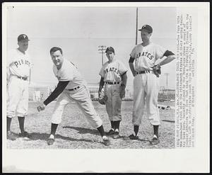 Come-Back Trail for Page -- Joe Page hits the come-back trail with the Pittsburgh Pirates at their spring training base here. Recently signed by the Bucs, Page shows a couple of younger pitchers the form that made him a fireballing fireman with the Yanks. Left to right: Pirate coach Clyde Sukeforth, Page, Larry Lassalle and Nelson King.
