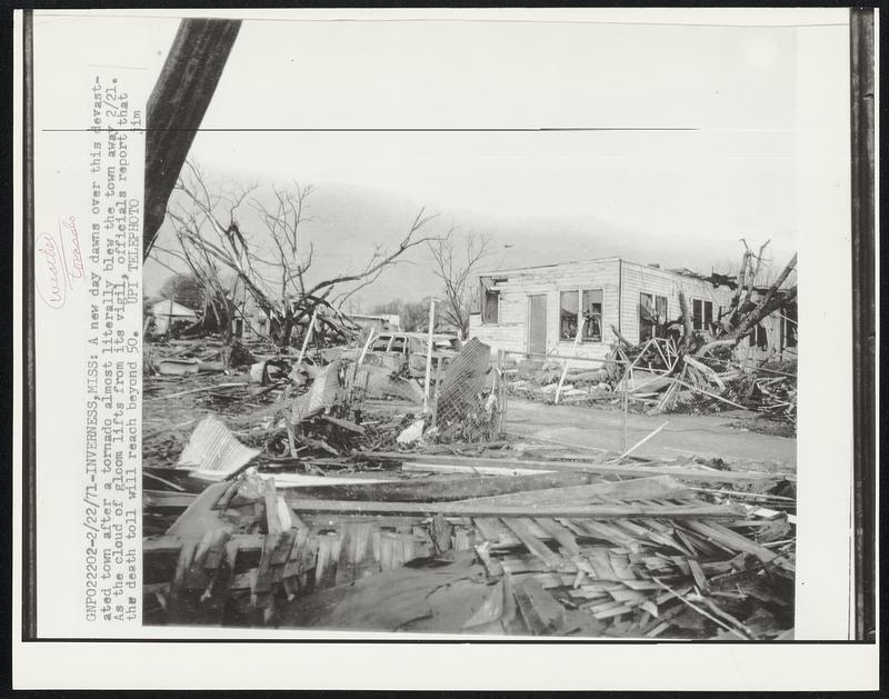 A new day dawns over this devastated town after a tornado almost literally blew the town away 2/21. As the cloud of gloom lifts from its vigil, officials report that the death toll will reach beyond 50.