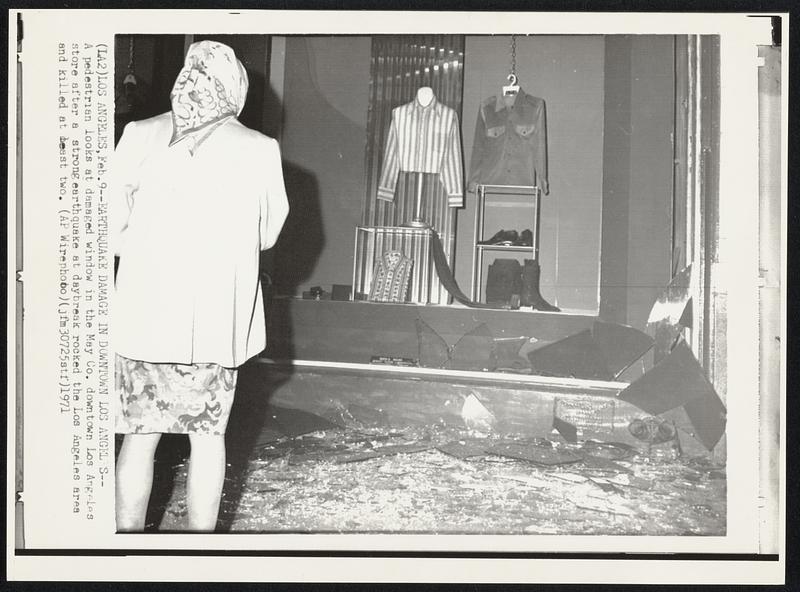 Earthquake Damage in Downtown Los Angeles -- A pedestrian looks at damaged window in the May Co. downtown Los Angeles store after a strong earthquake at daybreak rocked the Los Angeles area and killed at least two.