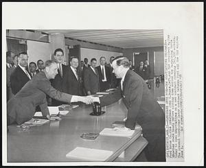 Handshake Gets Ford-UAW Negotiations Underway--Ford Motor Co. vice president John S. Bugas, left, and UAW president Walter P. Reuther shake hands before sitting down across the bargaining table today to open negotiations on a new contract covering 140,000 workers. The present three-year labor contract between Ford and the UAW expires June 1.